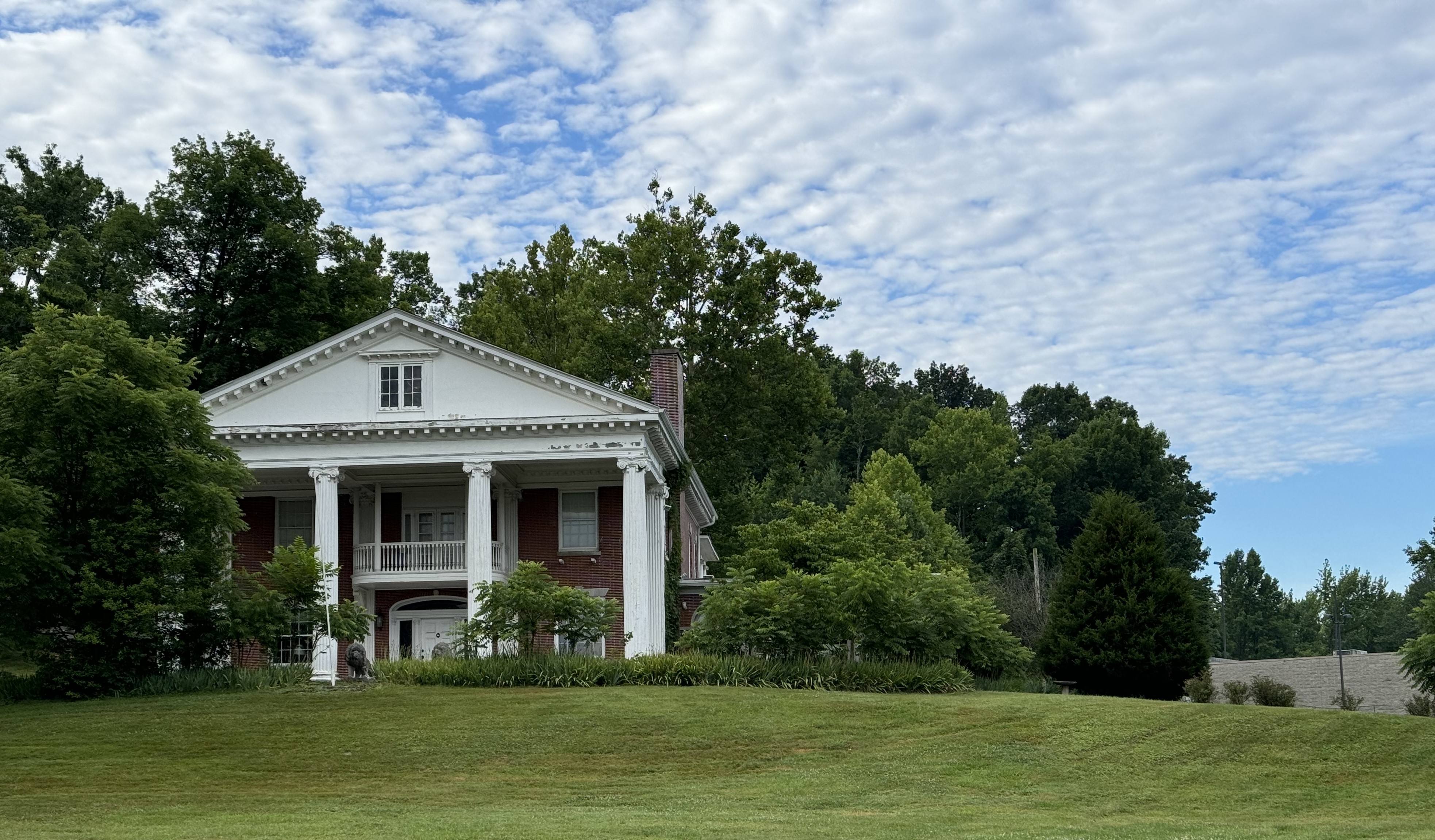 a house with a large porch and a large lawn